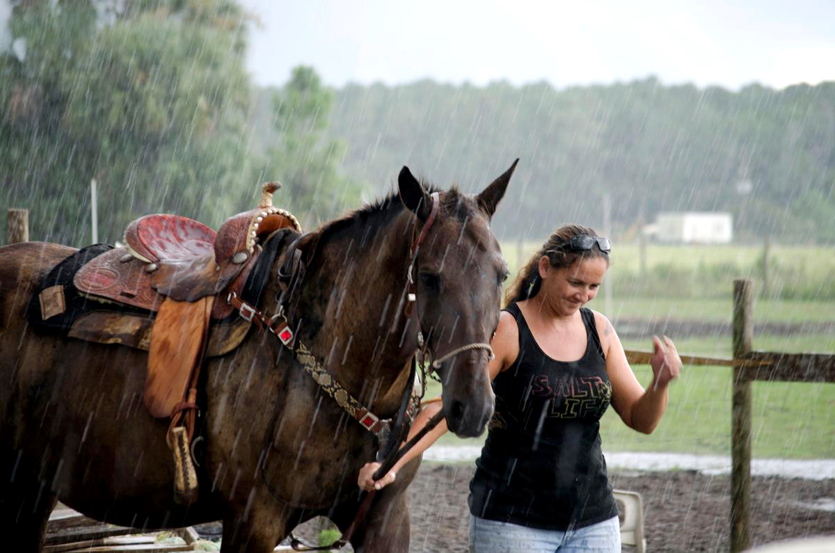 Jeannie Gonzalez, the owner of Stable Haven Horse Rescue, walks with Maggie, a rescused horse who has since been adopted into a loving home.